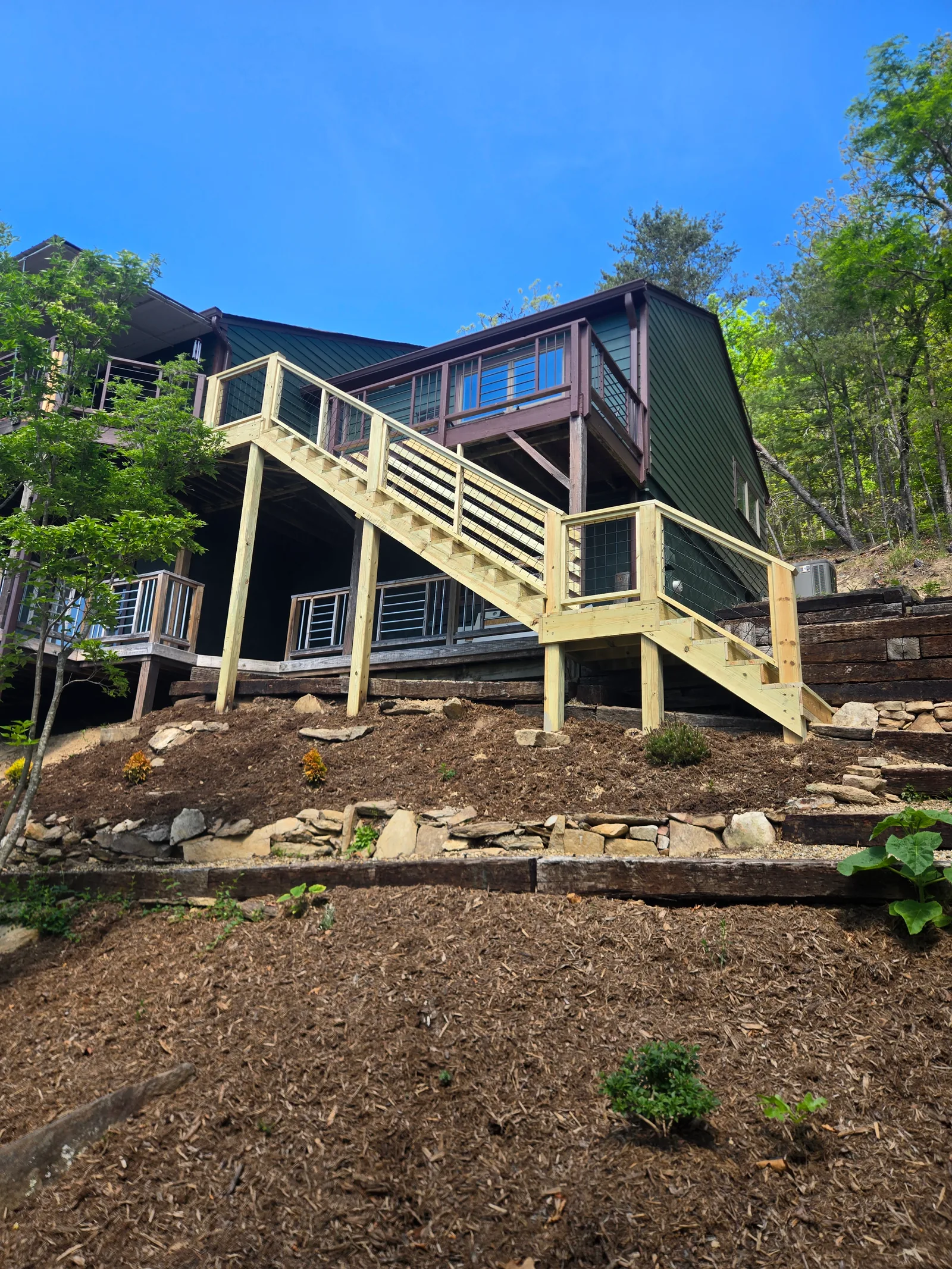 Side profile of a custom outdoor wood staircase with wire rail infill
