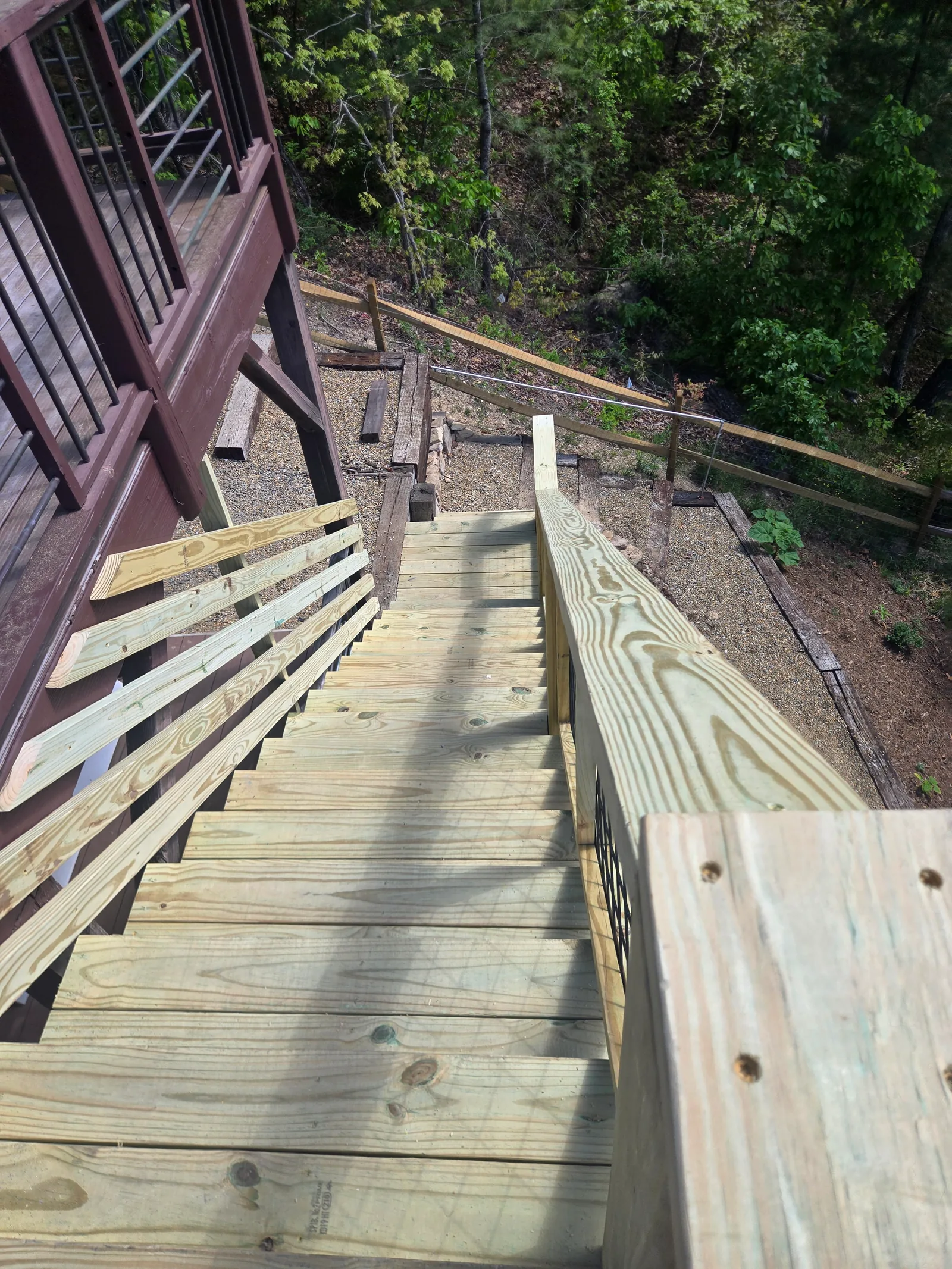 View down a new exterior stair run from the upper landing