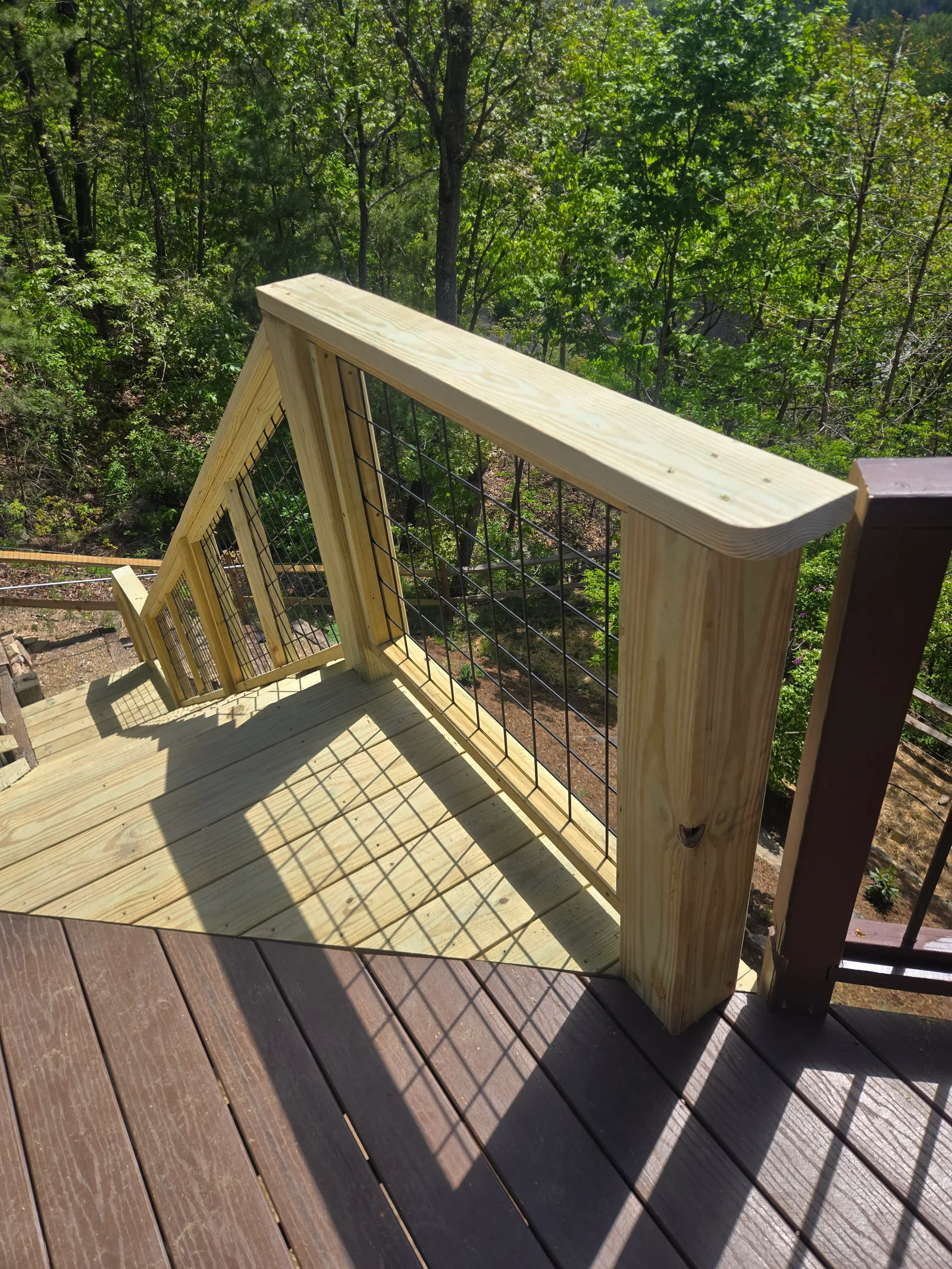 Upper landing and railing detail on an outdoor staircase