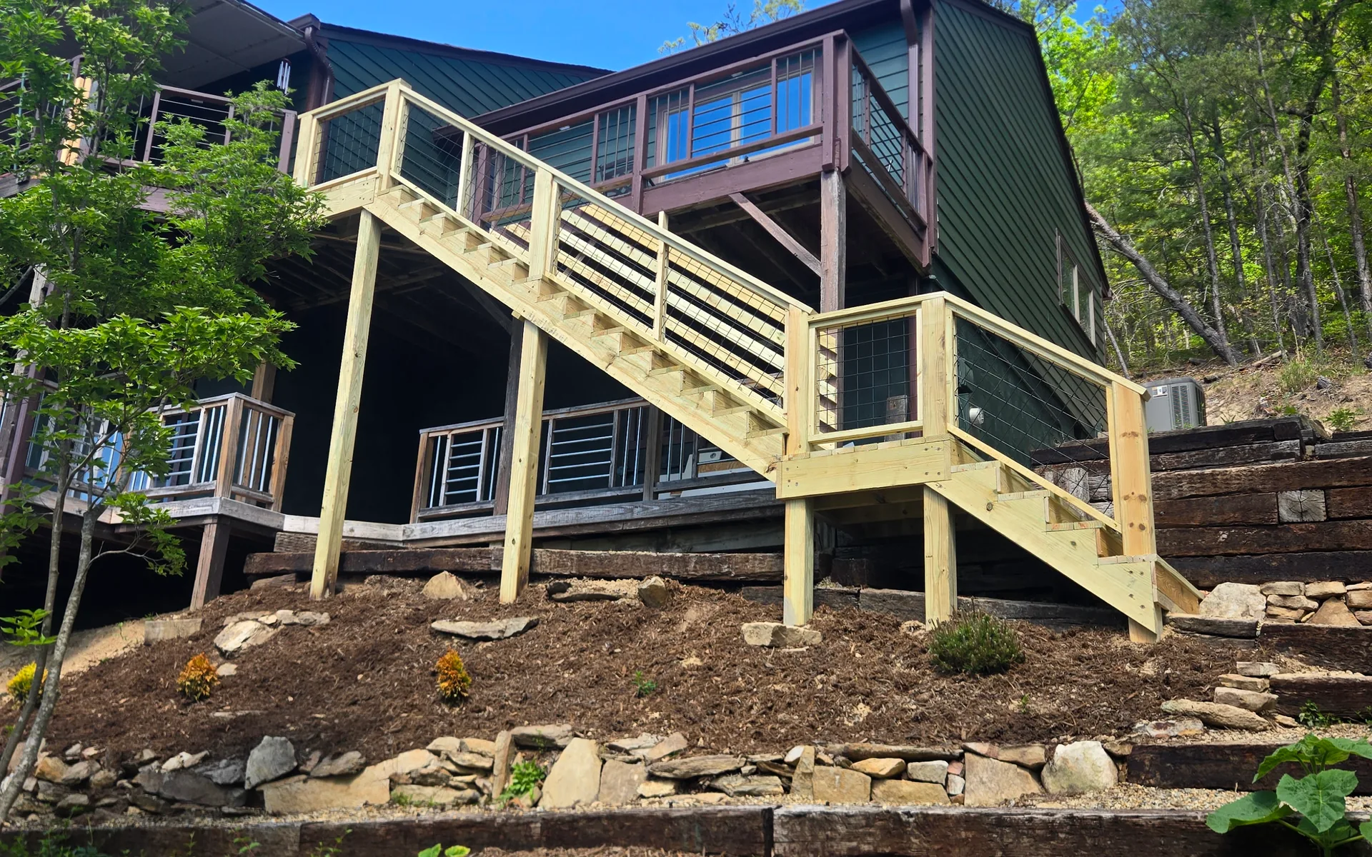 Outdoor hillside staircase with pressure treated railings